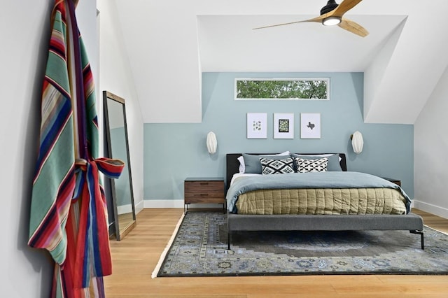 bedroom with baseboards, a ceiling fan, and wood finished floors