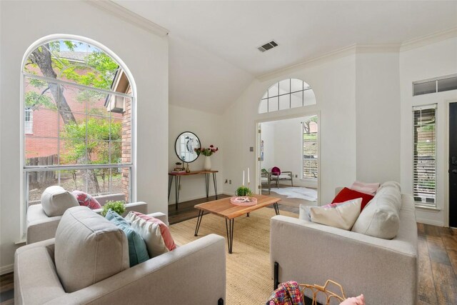 living room featuring visible vents, crown molding, wood finished floors, and lofted ceiling