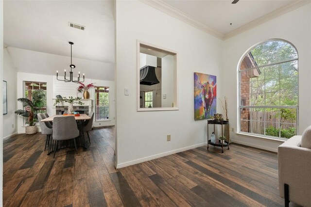 interior space featuring crown molding, an inviting chandelier, baseboards, visible vents, and dark wood-style floors