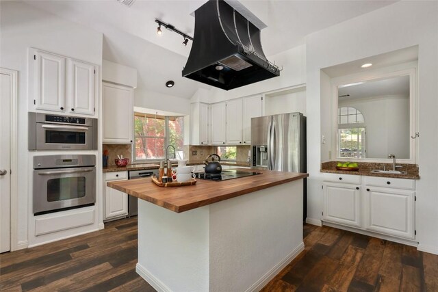 kitchen with island range hood, a sink, white cabinets, wood counters, and stainless steel appliances