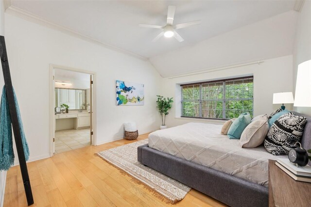 bedroom with ceiling fan, ensuite bathroom, vaulted ceiling, and wood finished floors