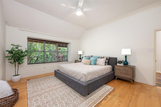 bedroom with ceiling fan, baseboards, vaulted ceiling, and light wood-style flooring