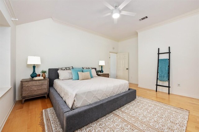 bedroom with crown molding, ceiling fan, visible vents, and light wood finished floors