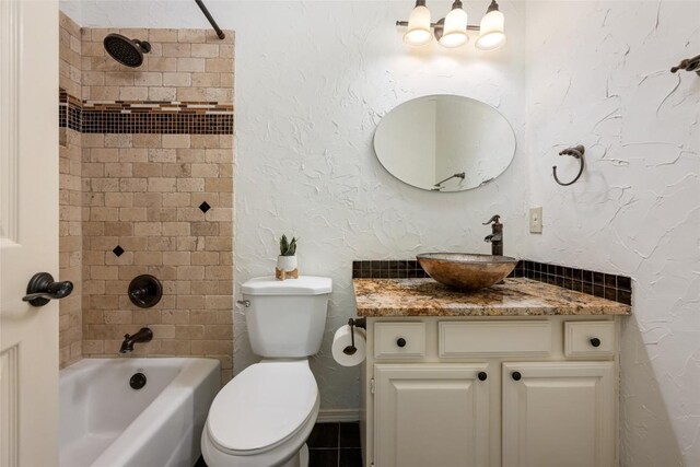 full bath with toilet,  shower combination, and vanity