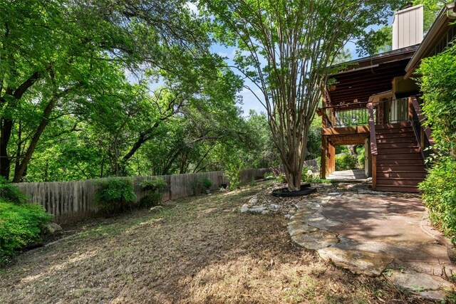 view of yard featuring stairs, a fenced backyard, and a patio area