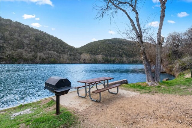 property view of water featuring a view of trees and a mountain view