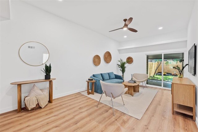 living area with recessed lighting, a ceiling fan, baseboards, and light wood finished floors