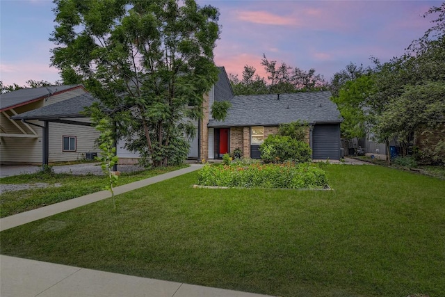 view of front of home with brick siding and a front yard