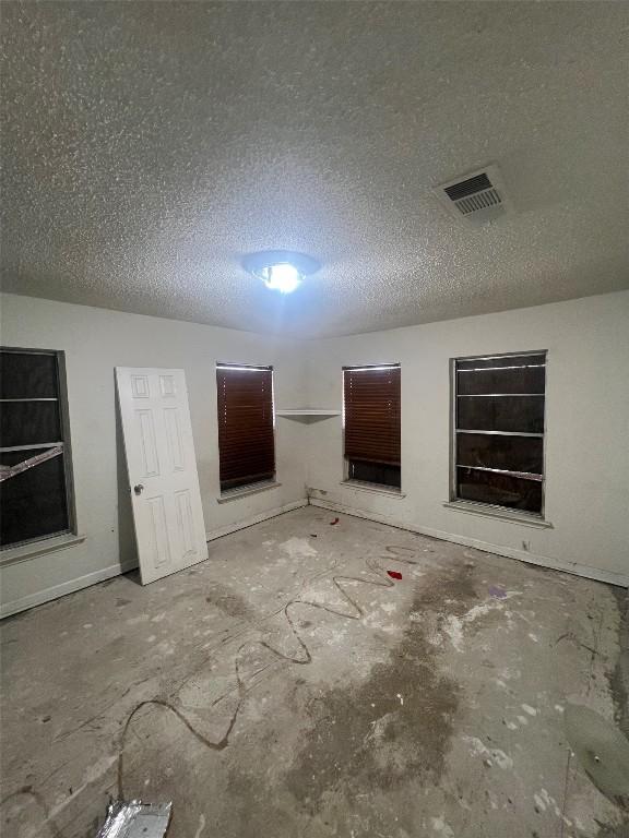 spare room with visible vents and a textured ceiling