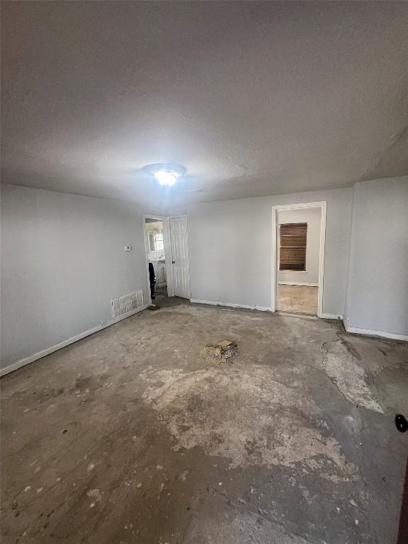basement featuring baseboards and visible vents