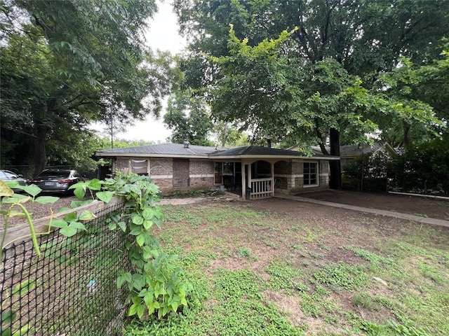 back of property featuring brick siding