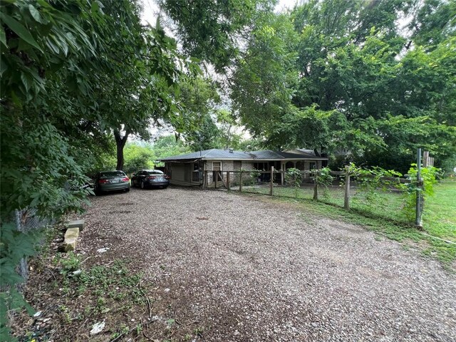 view of front of property with fence and driveway