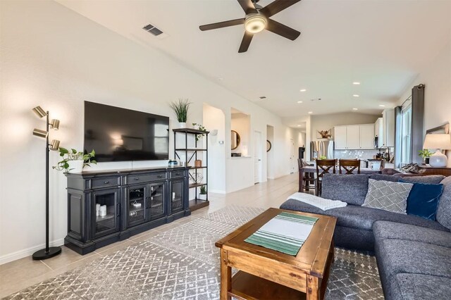 living area featuring ceiling fan, visible vents, light tile patterned floors, baseboards, and recessed lighting