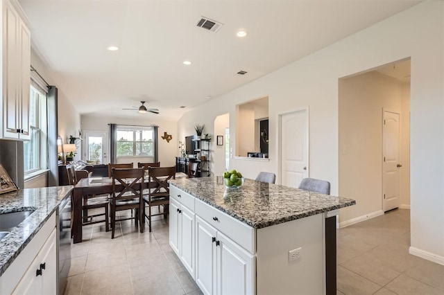 733 Melda St, Leander, TX 78641 - kitchen with ceiling fan, a kitchen island, light tile patterned floors, white cabinets, and recessed lighting