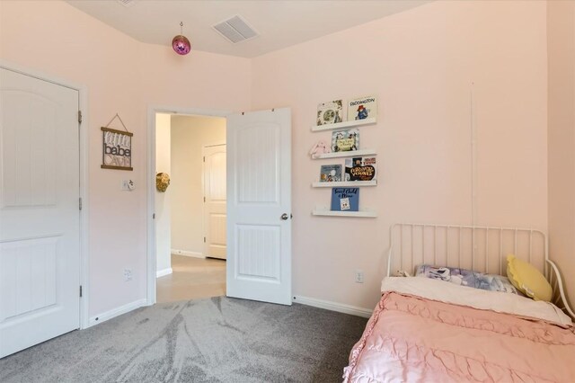 carpeted bedroom featuring visible vents and baseboards