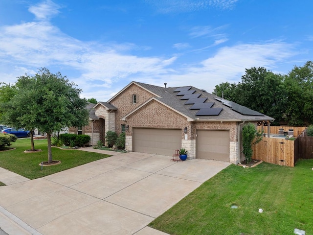 202 Parkwest Dr, Cedar Park, TX 78613 - ranch-style home featuring a garage, a front lawn, fence, concrete driveway, and solar panels