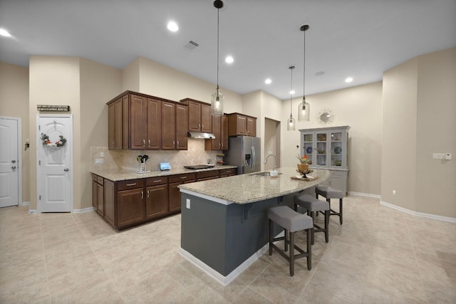 202 Parkwest Dr, Cedar Park, TX 78613 - kitchen featuring stainless steel refrigerator with ice dispenser, visible vents, a sink, black cooktop, and under cabinet range hood