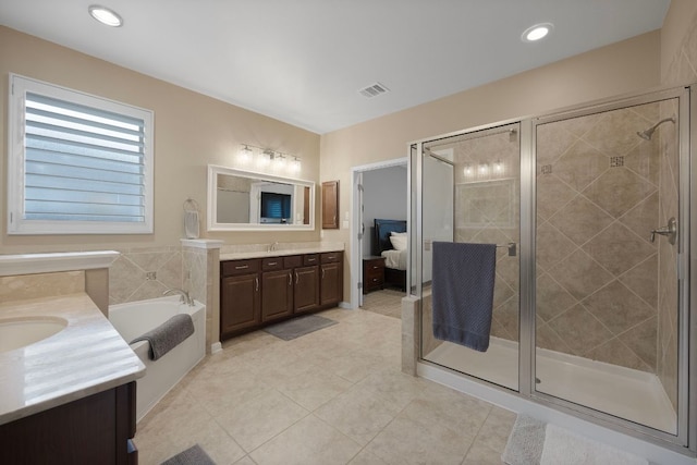 202 Parkwest Dr, Cedar Park, TX 78613 - bathroom with visible vents, a garden tub, tile patterned flooring, two vanities, and a stall shower