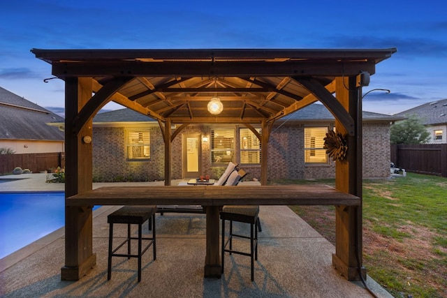 202 Parkwest Dr, Cedar Park, TX 78613 - patio terrace at dusk featuring a gazebo, fence, a fenced in pool, a yard, and outdoor dining space