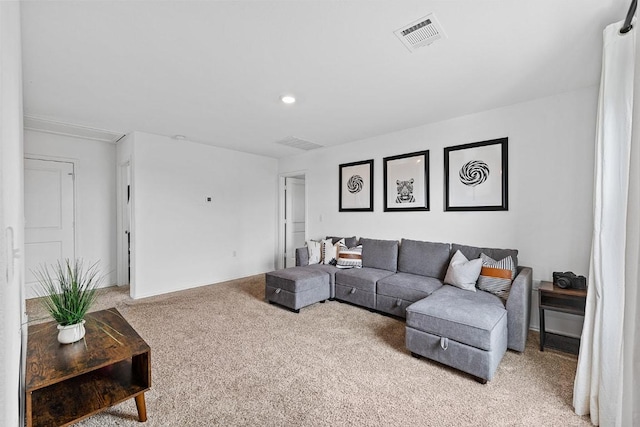carpeted living room with visible vents and recessed lighting