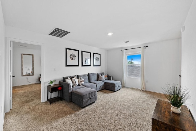 living room featuring visible vents and light carpet