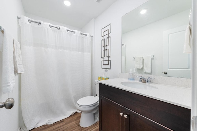 bathroom featuring vanity, toilet, recessed lighting, wood finished floors, and a shower with curtain