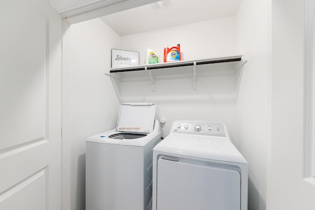 laundry area featuring separate washer and dryer and laundry area
