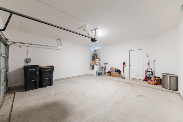 garage featuring water heater and a garage door opener