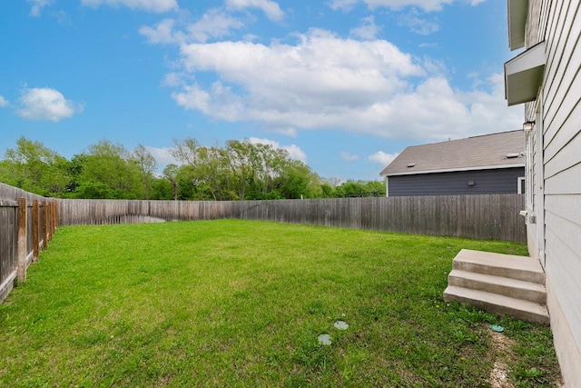 view of yard with a fenced backyard