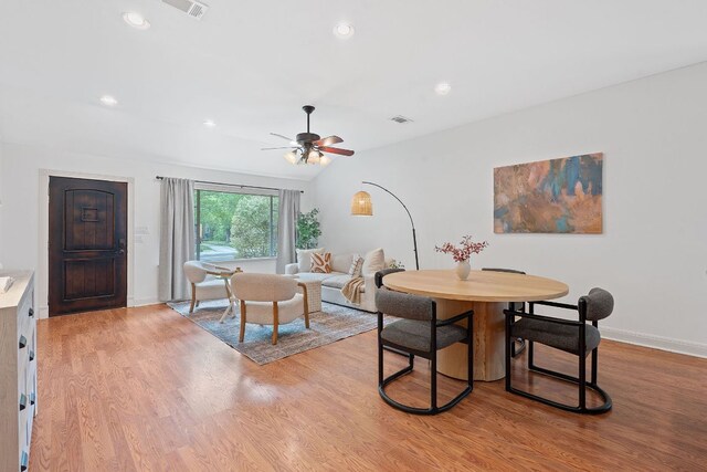 dining area with visible vents, light wood-style floors, and ceiling fan