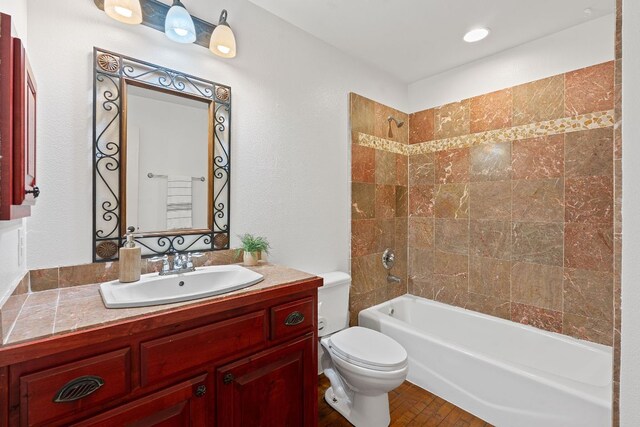 bathroom with vanity, shower / bathing tub combination, toilet, and wood finished floors