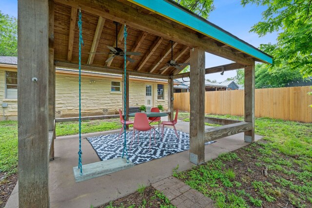 view of patio featuring ceiling fan and fence