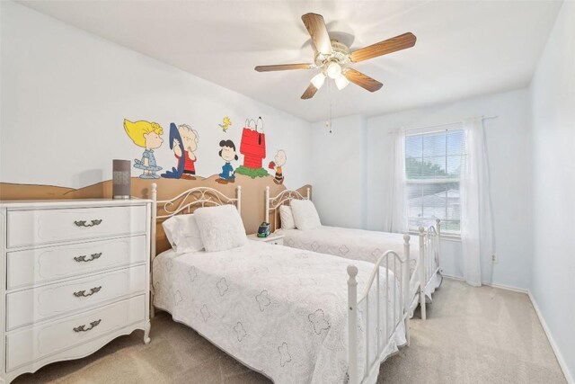 bedroom featuring baseboards, light carpet, and a ceiling fan
