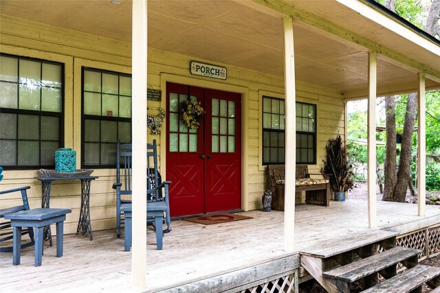 view of exterior entry featuring a porch