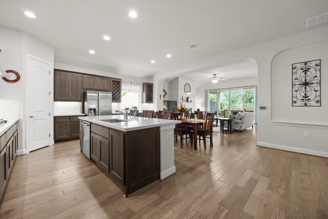 kitchen featuring visible vents, light wood-type flooring, light countertops, a sink, and appliances with stainless steel finishes