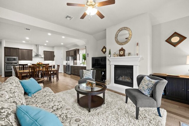 living area with recessed lighting, ceiling fan, visible vents, and light wood-style flooring