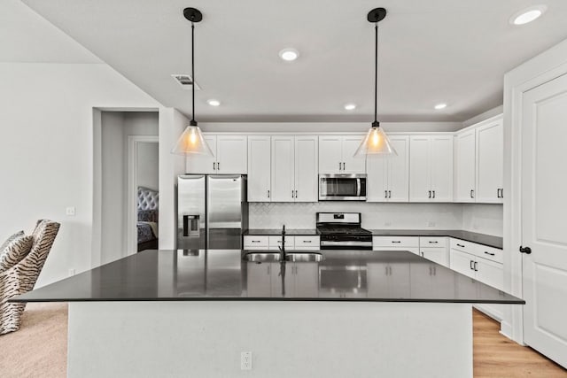 991 Hazy Hills Loop, Dripping Springs, TX 78620 - kitchen with a sink, white cabinetry, appliances with stainless steel finishes, and dark countertops