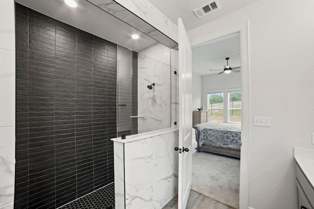 991 Hazy Hills Loop, Dripping Springs, TX 78620 - full bathroom with visible vents, wood finished floors, a walk in shower, connected bathroom, and a ceiling fan
