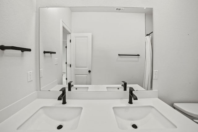 991 Hazy Hills Loop, Dripping Springs, TX 78620 - full bath with a sink, toilet, and double vanity