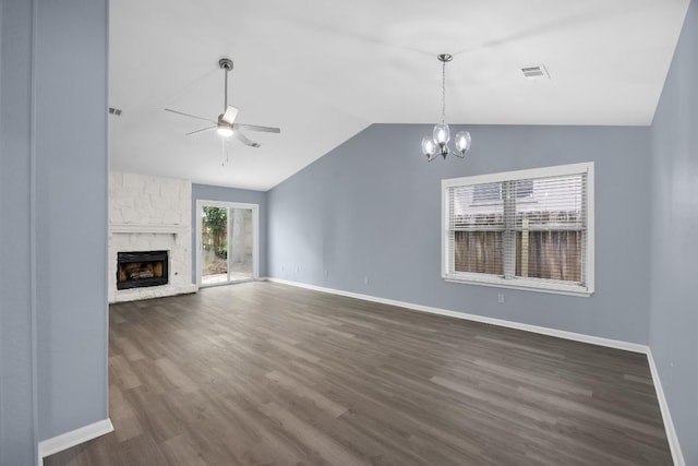 4411 Cumbria Ln, Austin, TX 78727 - unfurnished living room featuring vaulted ceiling, ceiling fan, a chandelier, dark wood-style floors, and a stone fireplace