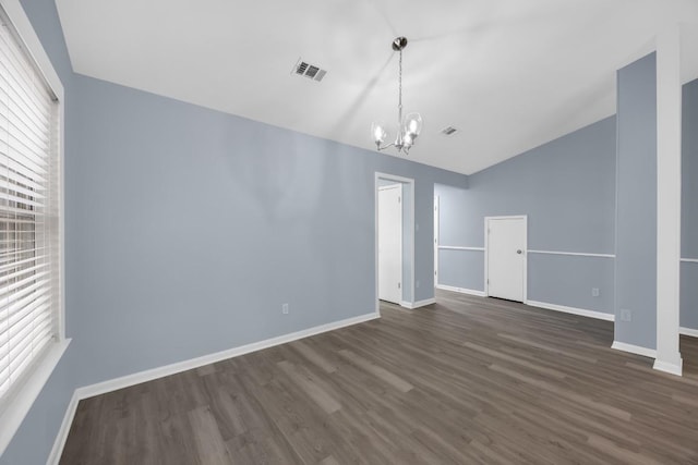 unfurnished dining area featuring a chandelier, vaulted ceiling, dark wood finished floors, and baseboards