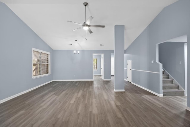 4411 Cumbria Ln, Austin, TX 78727 - unfurnished living room with ceiling fan, dark wood-style floors, a chandelier, stairway, and high vaulted ceiling