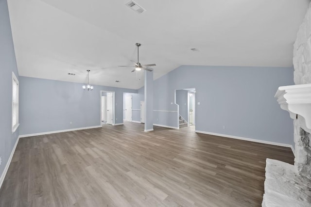 4411 Cumbria Ln, Austin, TX 78727 - unfurnished living room featuring a ceiling fan, a chandelier, stairway, lofted ceiling, and wood finished floors