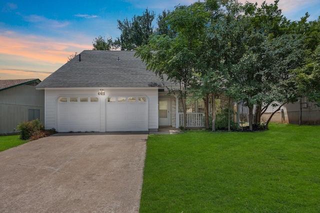 view of front of house with driveway, a garage, and roof with shingles