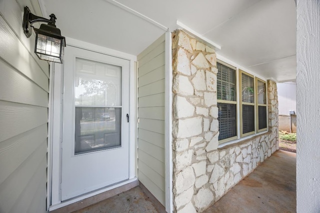 4411 Cumbria Ln, Austin, TX 78727 - property entrance with stone siding and a porch