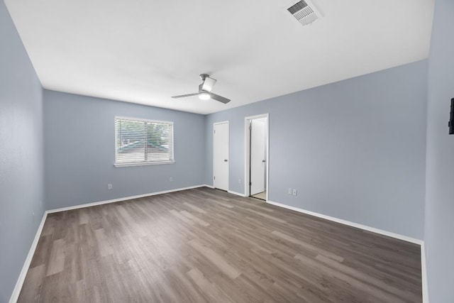 unfurnished bedroom featuring wood finished floors, baseboards, and ceiling fan