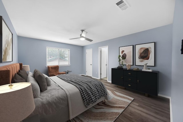 bedroom with wood finished floors, baseboards, and a ceiling fan