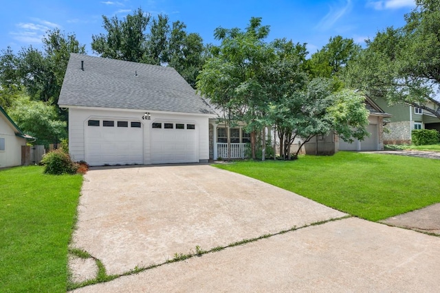 4411 Cumbria Ln, Austin, TX 78727 - view of front of home with a front lawn, a shingled roof, an attached garage, and driveway