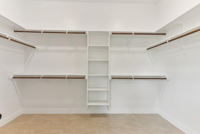 walk in closet with tile patterned floors