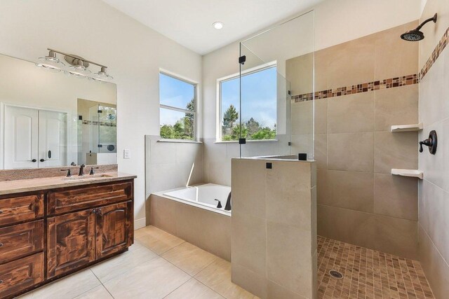 bathroom featuring a walk in shower, vanity, tile patterned floors, and a garden tub